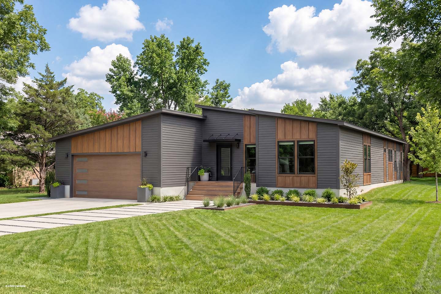 Modern single-story house with dark siding, wood accents, large windows, and a well-manicured green lawn.